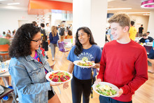 Group of students walking through the dining hall. 