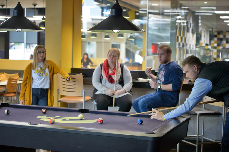 Students playing a game of pool