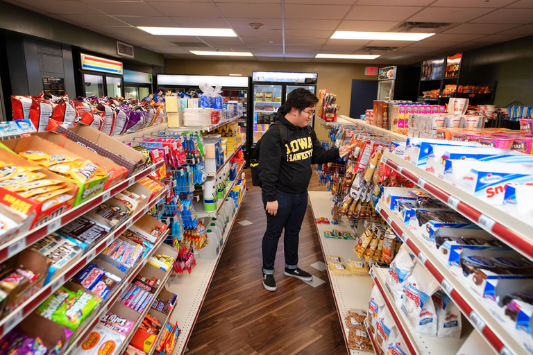 Student grabbing items from shelf