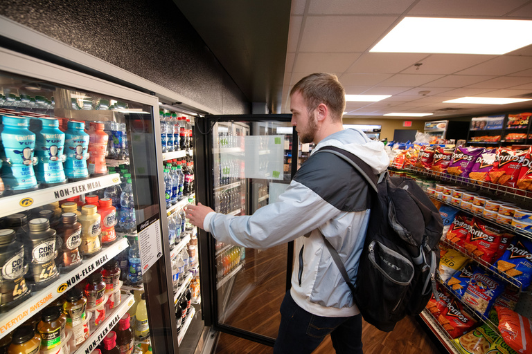 Student grabbing drink from cooler