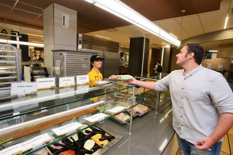 Student taking plate of food