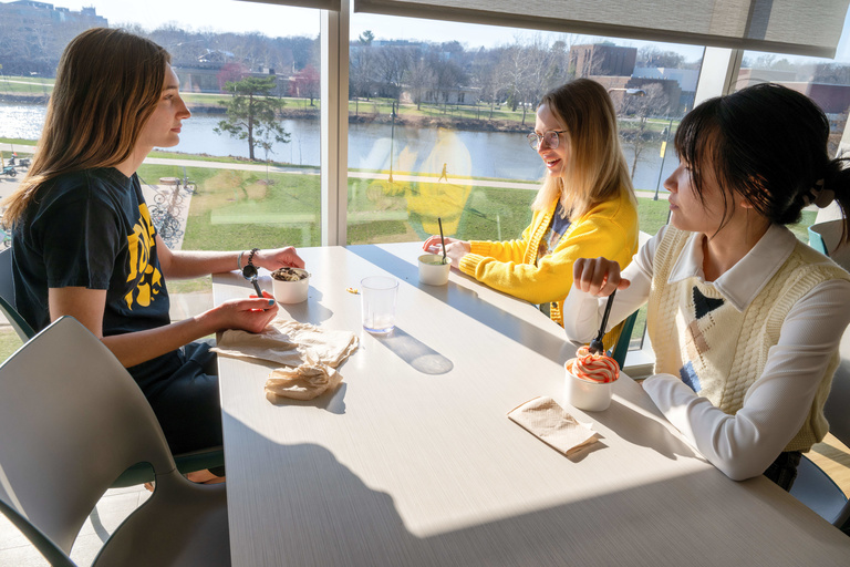 Three students sitting together and eating
