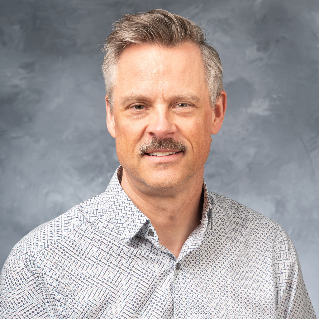 portrait of DVH with mustache, grey button down shirt