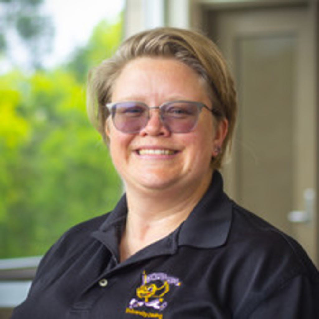 Headshot of Sara Castlebury, blonde woman wearing glasses and a black polo