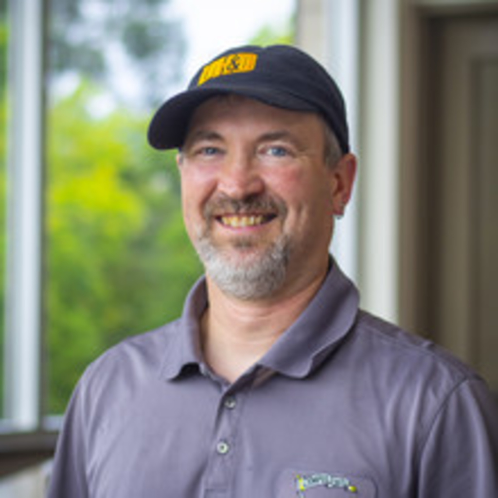 Man wearing black UHD ball cap and gray polo shirt