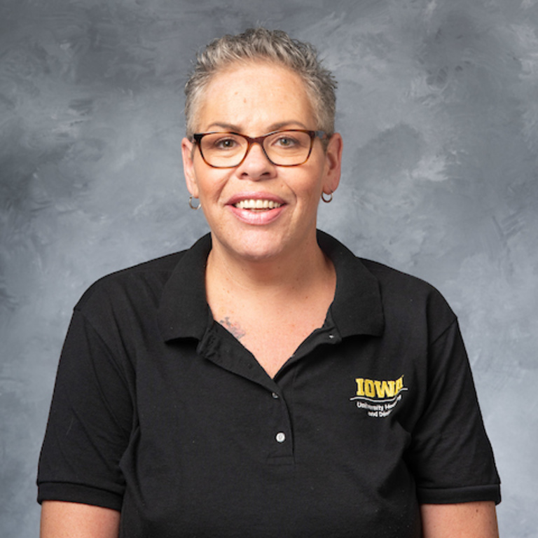 headshot of Heidi Pyos, woman wearing glasses and a black collared UHD t-shirt