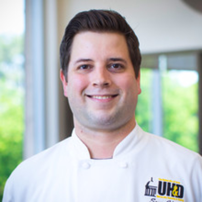 headshot of chef Ben Hines at Catlett, wearing white chef's coat