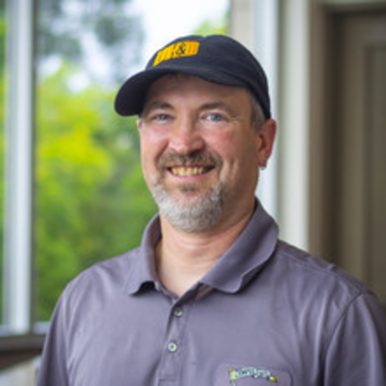 Man wearing black UHD ball cap and gray polo shirt